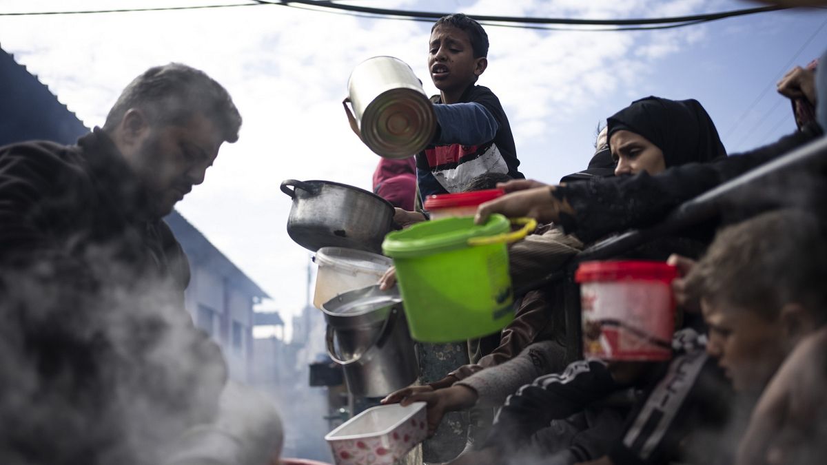 Palestinians line up for a free meal in Rafah, Gaza Strip, Friday, Feb. 16, 2024.