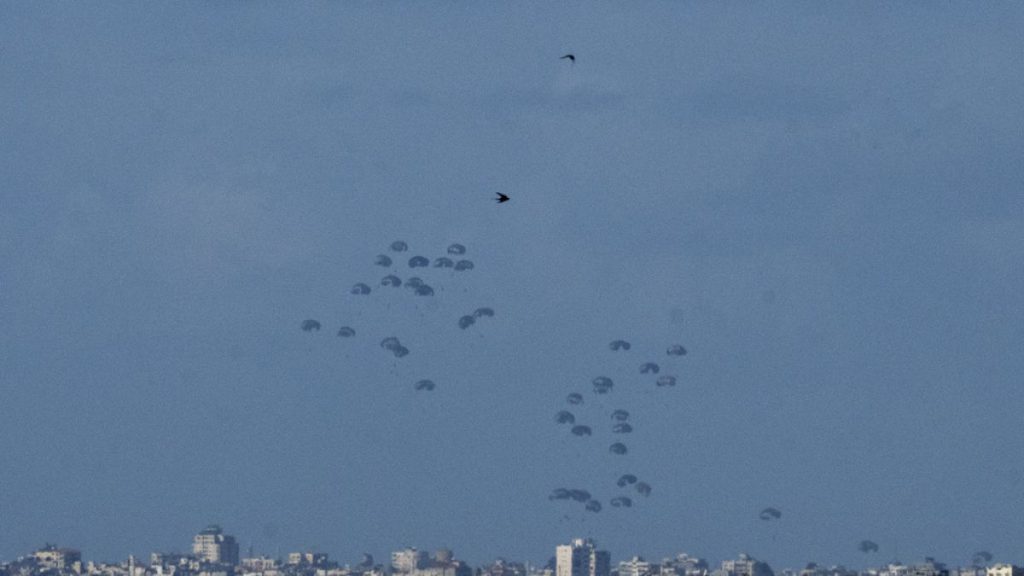 Parachutes drop supplies into the northern Gaza Strip, as seen from southern Israel, Thursday, March 7