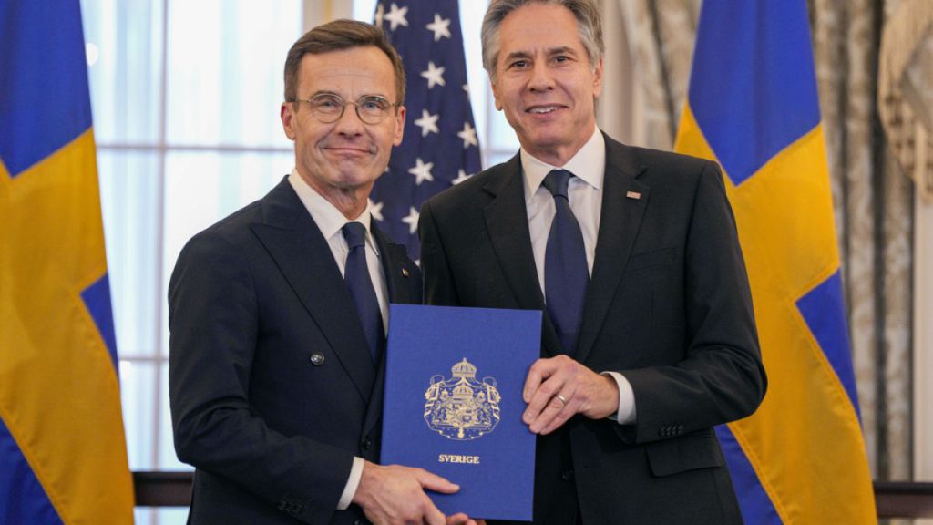 Secretary of State Antony Blinken is seen with Swedish Prime Minister Ulf Kristersson holding Sweden