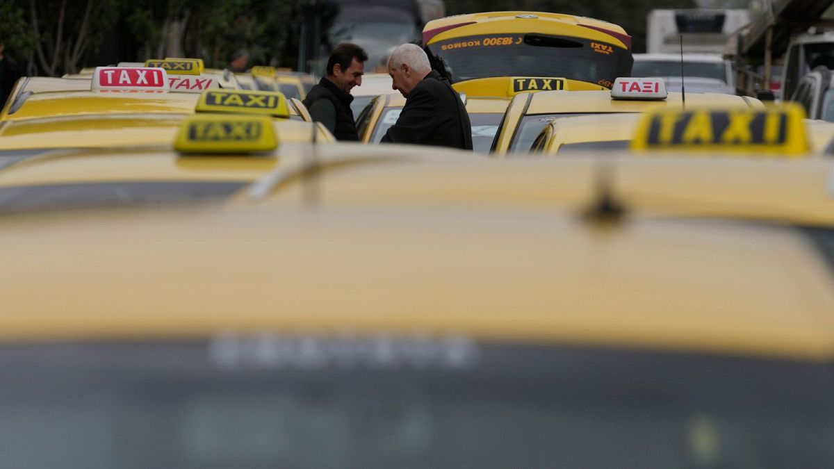 Taxi drivers gather during their rally in Athens, Greece, Tuesday, Feb. 27, 2024.