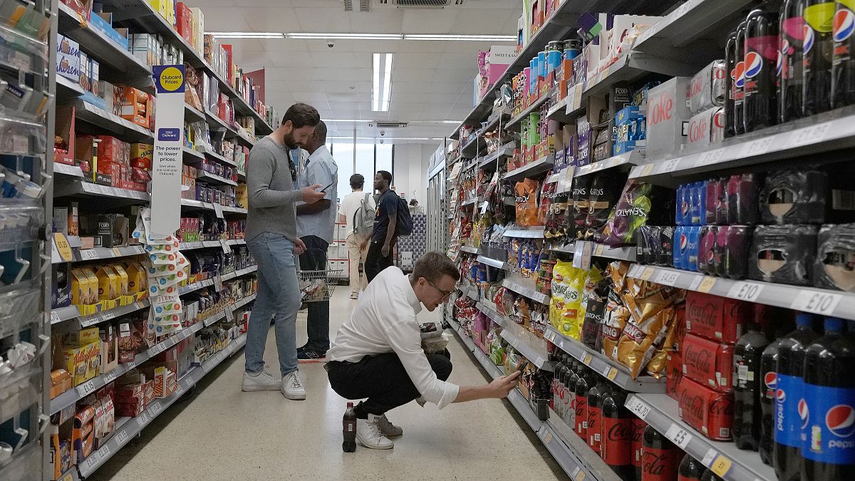 Shoppers buy food in a supermarket in London, Wednesday, Aug. 17, 2022.