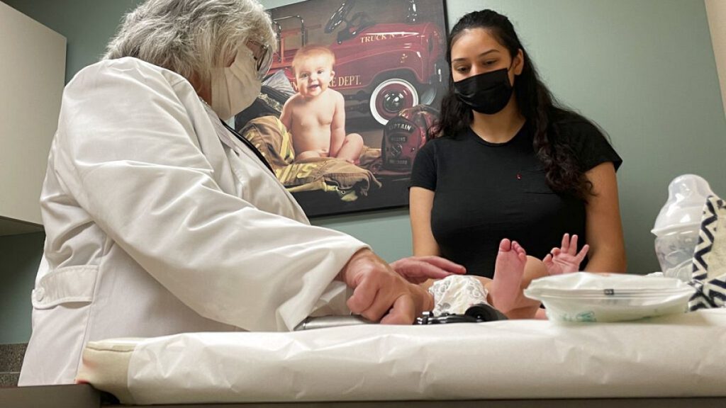 Dr. Sara Goza explains an infant