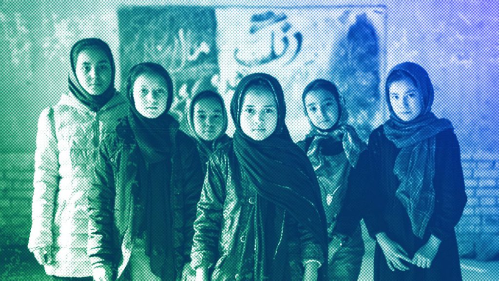 Afghan schoolgirls pose for a photo in a classroom in Kabul, December 2022