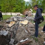People look at fragments of the television tower which was broken in half after it was hit by a Russian missile in Kharkiv, Ukraine, Monday, April 22, 2024.