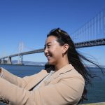 Content creator Cynthia Huang Wang works below the San Francisco-Oakland Bay Bridge in San Francisco, Monday, April 8, 2024.