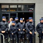 Police stand guard outside the front entrance of the event venue as the National Conservatism conference takes place in Brussels, Tuesday, April 16, 2024.