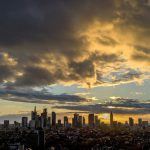 The sun sets behind the skyline as clouds drift by in Frankfurt, Germany, Tuesday, Nov. 7, 2023