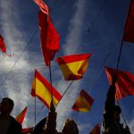 Demonstrators waves Spanish and Navarre flags as they protest against the amnesty at Plaza del Castillo square, in Pamplona, northern Spain, Saturday, Nov. 18, 2023.