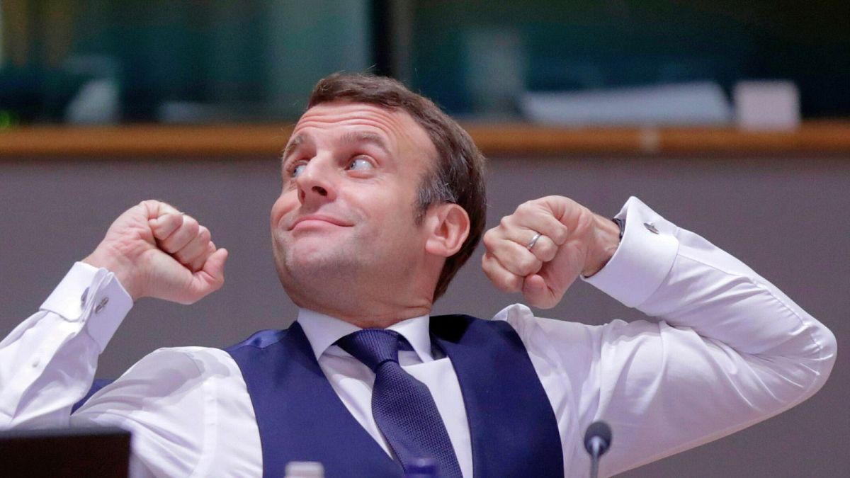 Macron stretches after an all night negotiating session at an EU summit in Brussels, December 2020, where leaders have agreed to cut the bloc