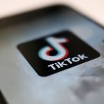 A logo of a smartphone app TikTok is seen on a user post on a smartphone screen