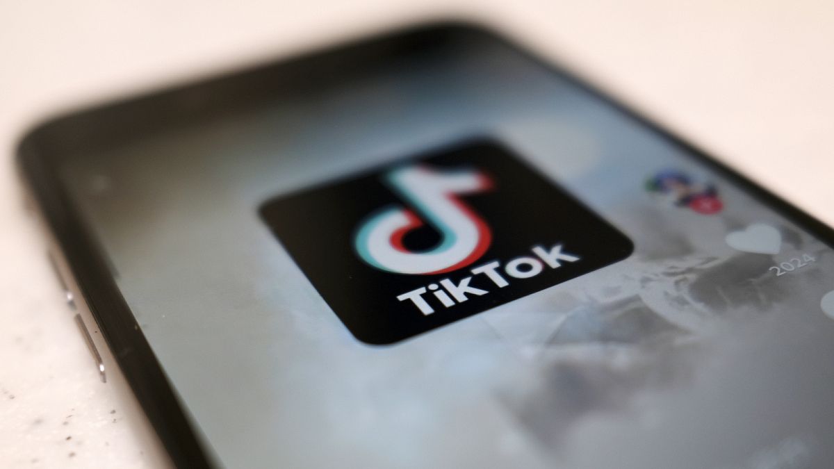 A logo of a smartphone app TikTok is seen on a user post on a smartphone screen