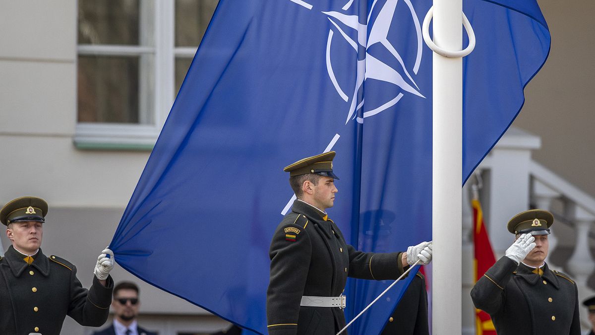 Soldiers stand for a flag-raising ceremony during a celebration for Lithuania