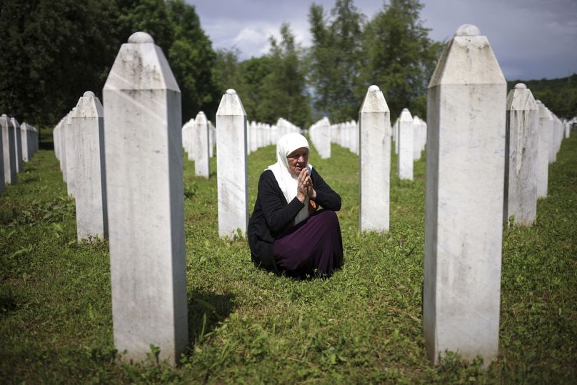 Mejra Djogaz opłakuje groby swoich dwóch synów, ofiar ludobójstwa w Srebrenicy, w Centrum Pamięci w Potocari w Bośni, środa, 22 maja 2024 r.