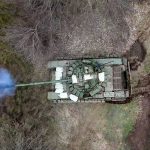 A Russian tank fires its cannon at Ukrainian troops from a position near the border with Ukraine in the Belgorod region, Russia
