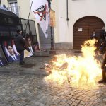 Protesters light fire before burning giant photographs of leaders, Turin, Italy, Sunday, April 28, 2024.