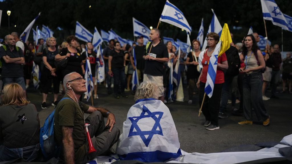 People take part in a protest against Israeli Prime Minister Benjamin Netanyahu