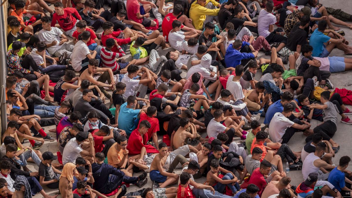 Unaccompanied minors who crossed into Spain are gathered outside temporary shelter in Ceuta, near the border of Morocco and Spain, Wednesday, 19 May, 2021.