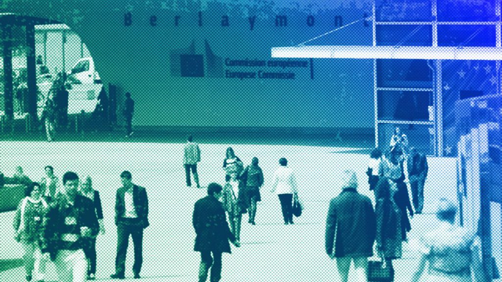 People walk past the European Commission headquarters in Brussels, May 2012