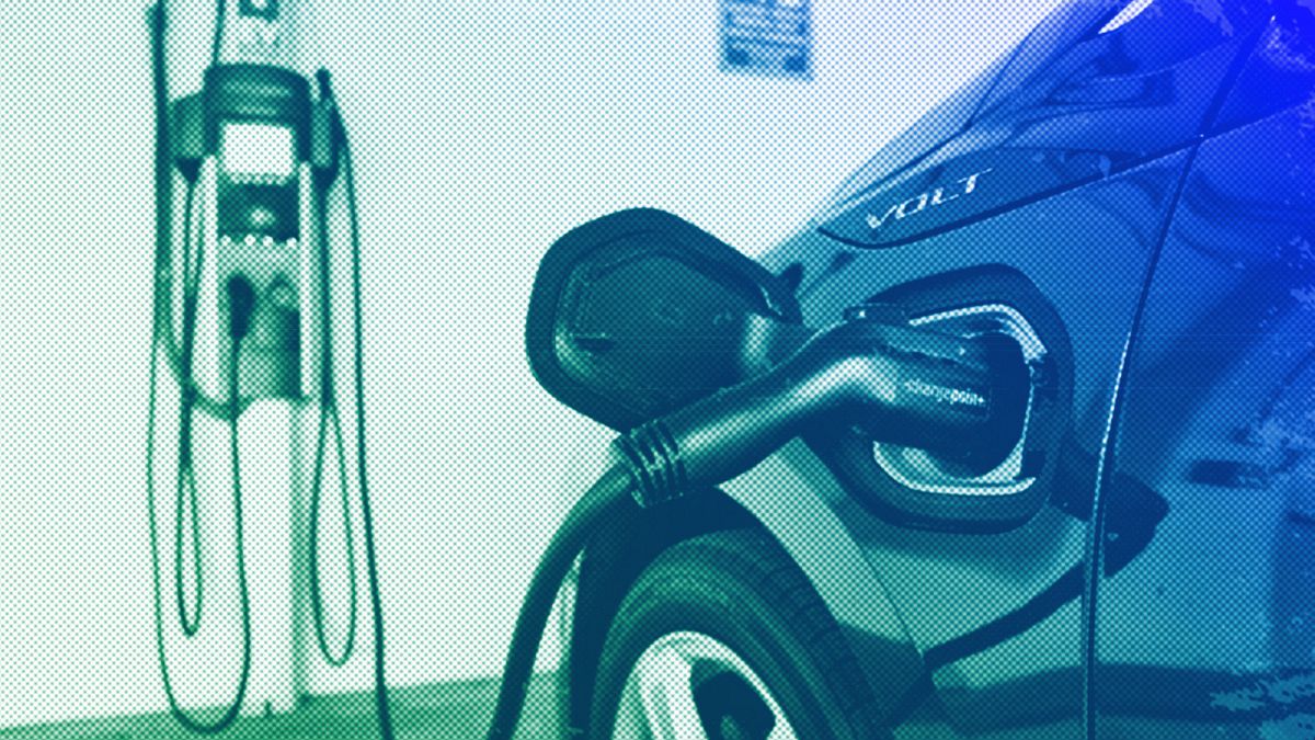 A hybrid car is seen charging at a charging station at a parking garage in Los Angeles, October 2018