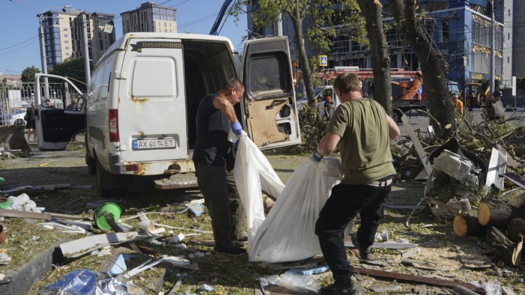 Workers carry a dead body killed after an apartment building was hit by Russian air bomb killing at least three and injuring 23, in Kharkiv, Ukraine, Saturday, June 22nd 2024