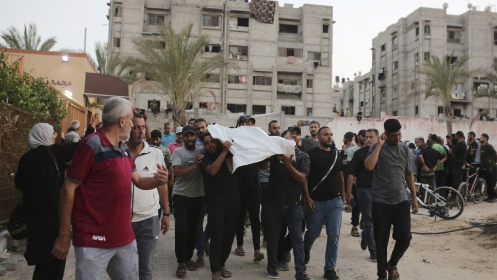 Palestinians carry a person killed by Israeli bombardment to their burial in Khan Younis, southern Gaza Strip, Friday, June 21, 2024. (AP Photo /Jehad Alshrafi)