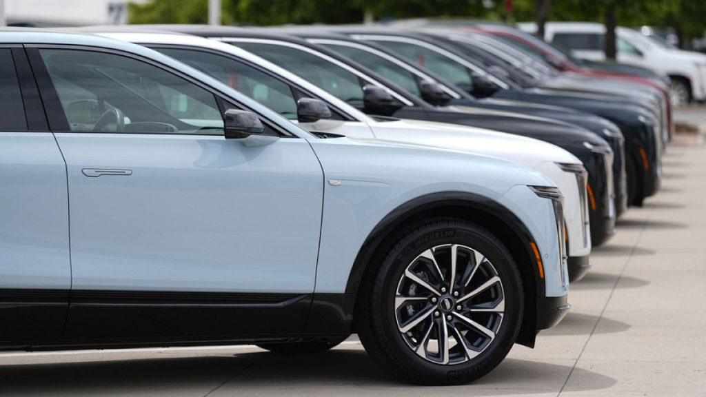 Unsold 2024 electric Lyriq utility vehicles sit in a row outside a Cadillac dealership Sunday, June 2, 2024, in Lone Tree, Colo. (AP Photo/David Zalubowski)