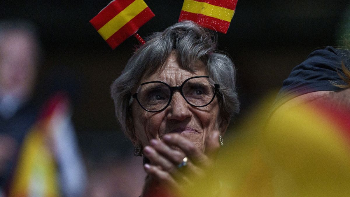 A supporter with a Spanish flags in her head takes part during the Spanish far-right wing party Vox