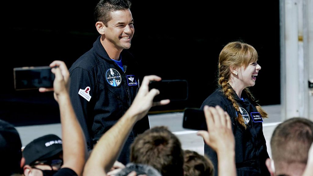 FILE - Jared Isaacman, left, and Hayley Arceneaux prepare to head to launchpad 39A for a launch on a SpaceX Falcon 9 at the Kennedy Space Center in Cape Canaveral, Florida.