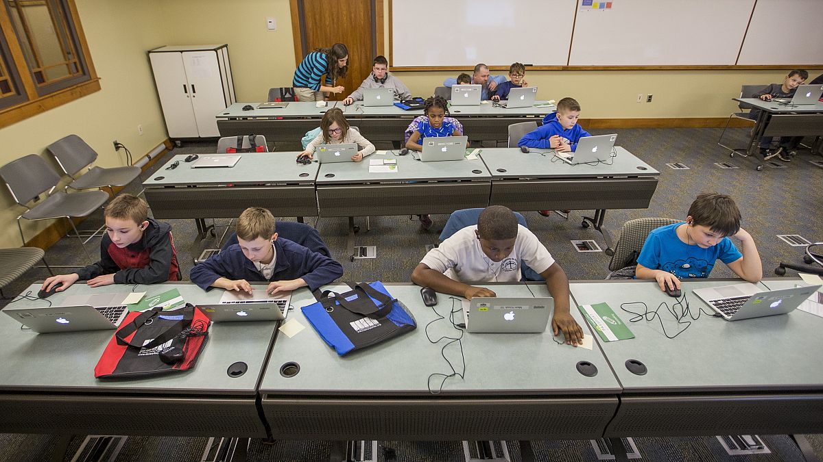 Children work on laptops during class.