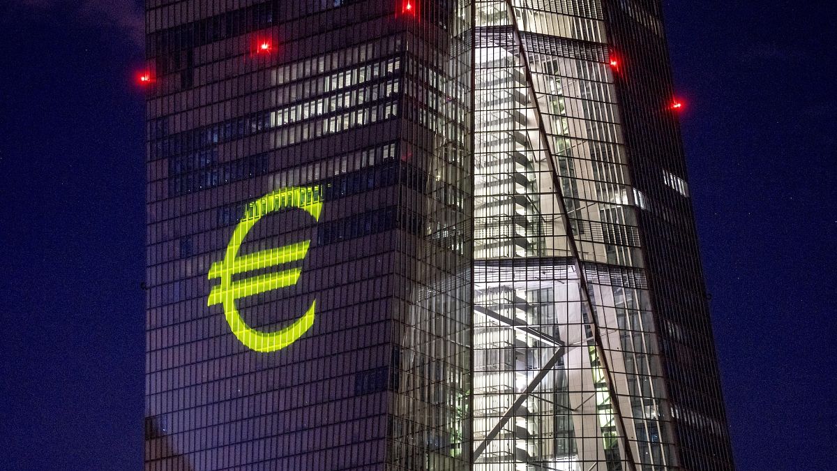 A light installation depicting the euro on the European Central Bank