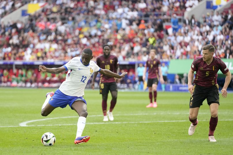 Randal Kolo Muani z Francji strzela na bramkę, co powoduje, że Belg Jan Vertonghen (po prawej) strzela samobójczego gola w meczu 1/8 finału Francja-Belgia