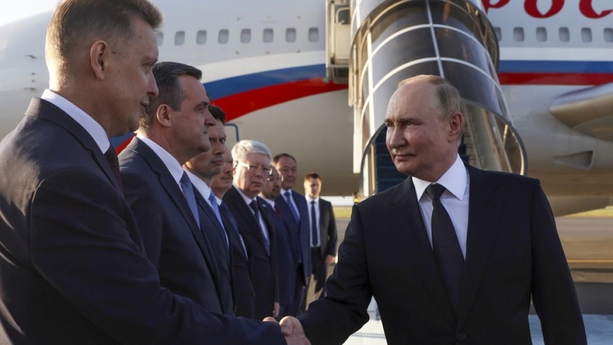 Russian President Vladimir Putin shakes hands with diplomats upon his arrival at the international airport in Astana, Kazakhstan, Wednesday, July 3, 2024.