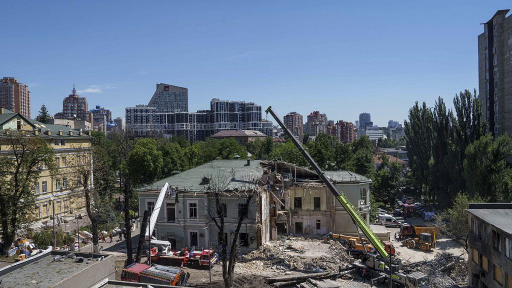 Rescue workers clear the rubble at the site of Okhmatdyt Children