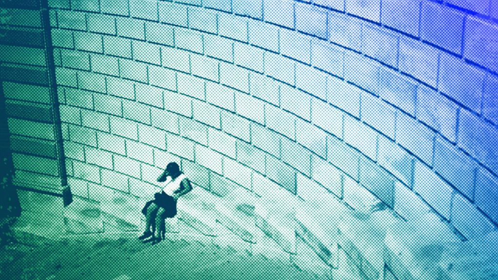 A woman sits down during high temperatures in Marseille, August 2023