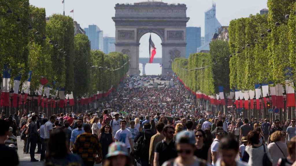 People walk on the Champs Elysees in Paris, France, Sunday, May 8, 2016.