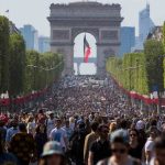 People walk on the Champs Elysees in Paris, France, Sunday, May 8, 2016.