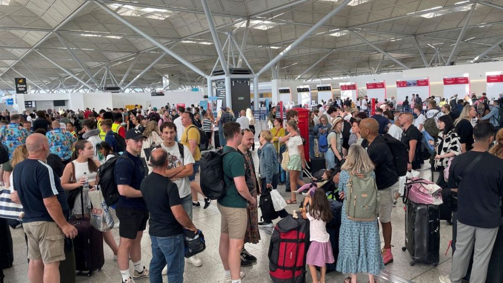 Passengers queueing at London Stansted Airport in Essex, amid reports of widespread IT outages affecting airlines, broadcasters and banks, 19 July, 2024.