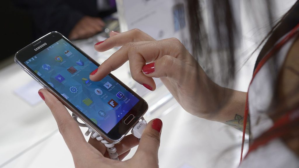 A woman uses a Samsung phone in Barcelona, Spain.