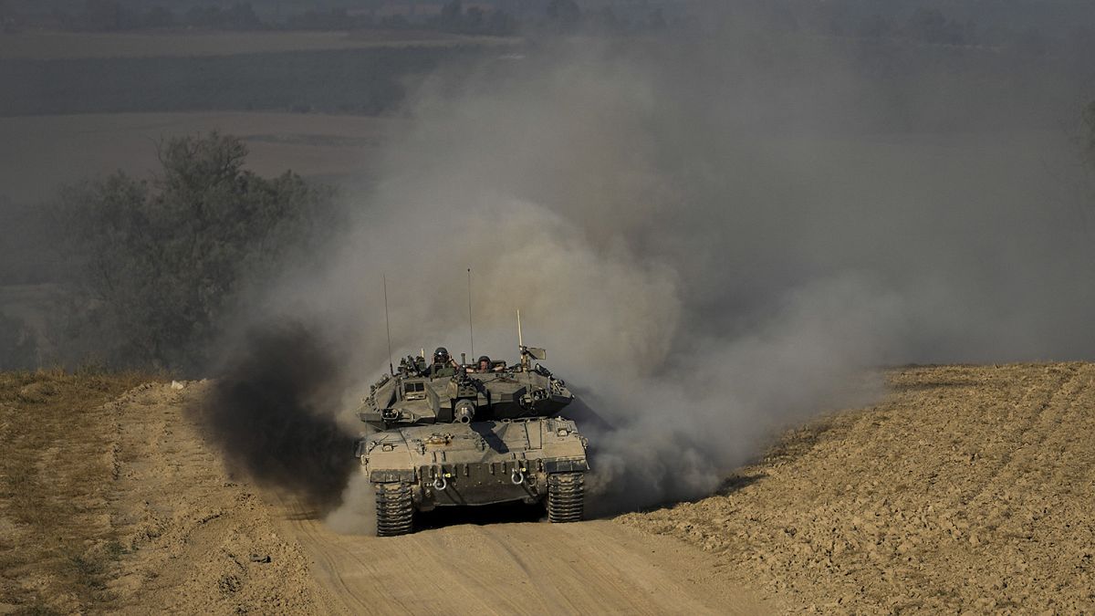 Israeli soldiers drive a tank near the Israeli-Gaza border, in southern Israel, 5 June 2024