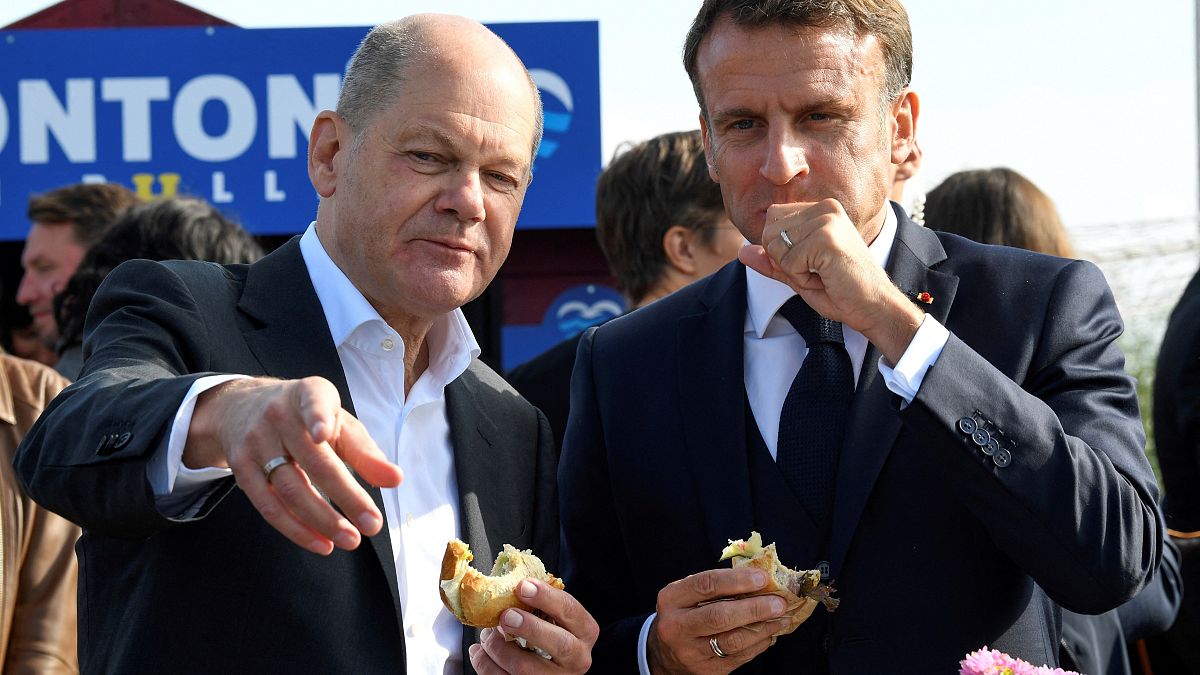 Scholz and Macron eating fish sandwiches in Hamburg on Oct 10, 2023