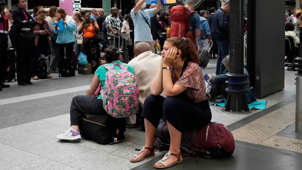 A traveler waits inside the Gare du Nord train station at the 2024 Summer Olympics, Friday, July 26, 2024, in Paris, France.