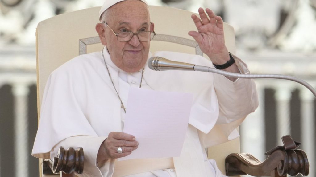 Pope Francis waves during his weekly general audience in the St. Peter