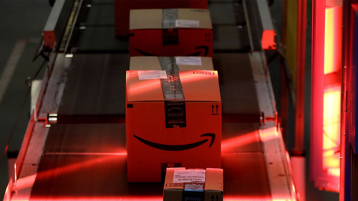 Packages riding on a belt are scanned to be loaded onto delivery trucks at the Amazon Fulfillment centre in New Jersey, 1 August 2017, FILE