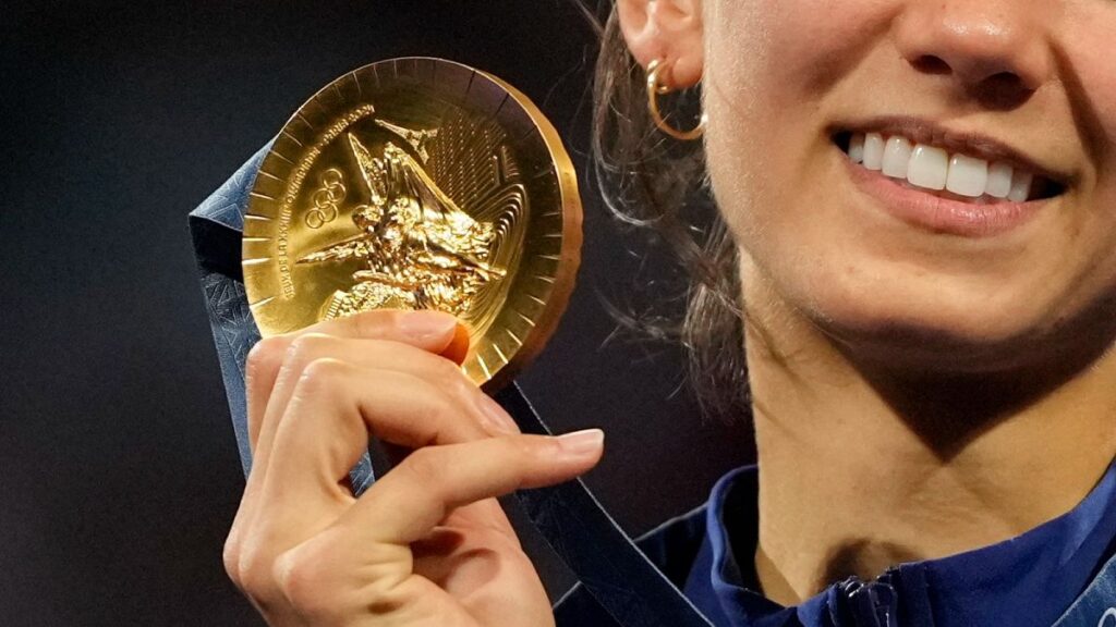 A close-up of a Paris 2024 gold medal as Team US Lee Kiefer celebrates winning the women