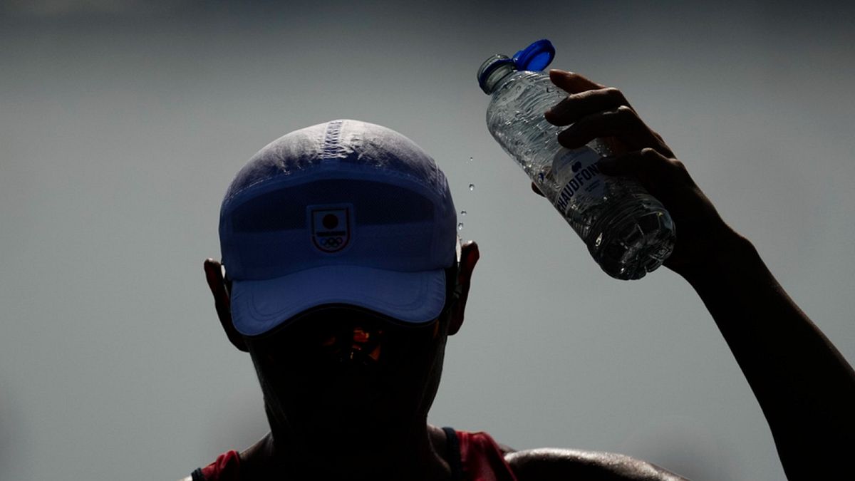 Ryuta Arakawa, of Japan, cools himself off ahead of the men