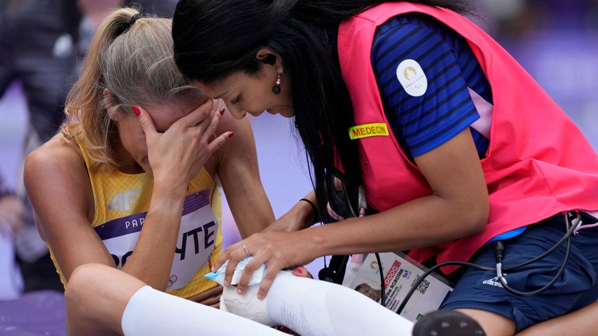 Airine Palsyte, of Lithuania, receives medical assistance after getting injured during the women