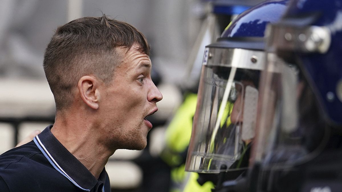 Protesters confront police during the