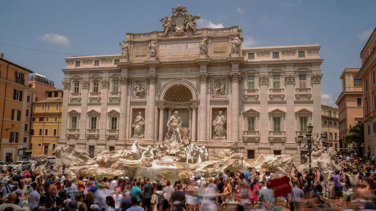 Tourists visit the Trevi Fountain in Rome.