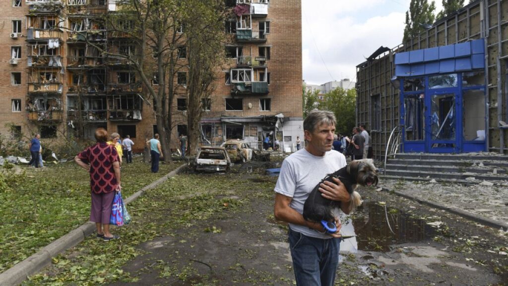 Residents of an apartment building damaged after shelling by the Ukrainian side leave the area in Kursk, Russia, Sunday, Aug. 11, 2024.