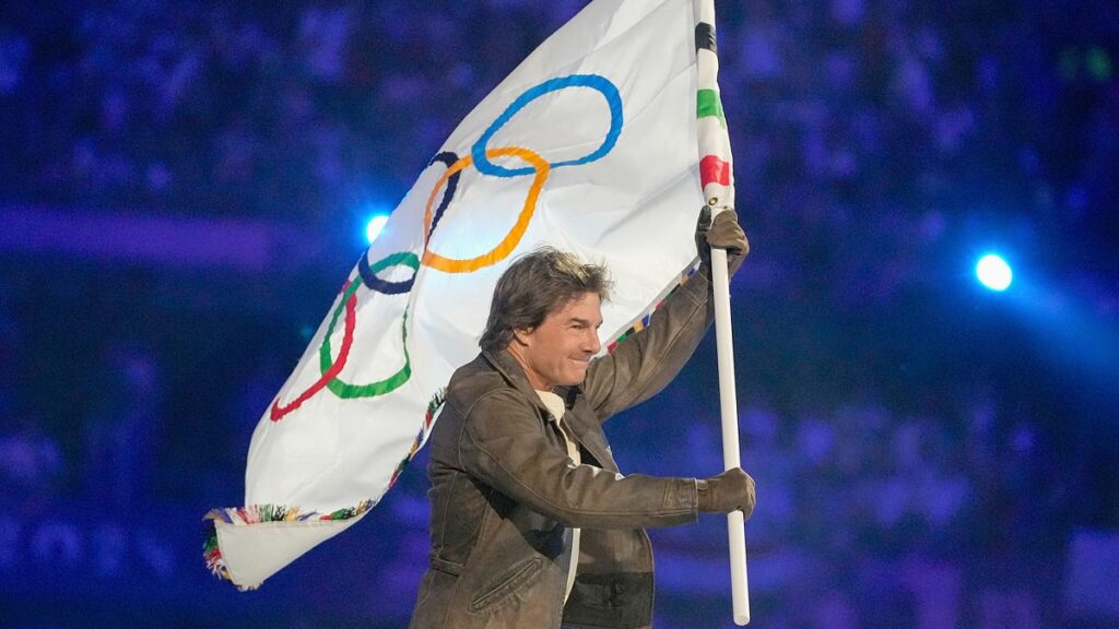 Tom Cruise carries the Olympic flag during the 2024 Summer Olympics closing ceremony at the Stade de France, 11 August 2024